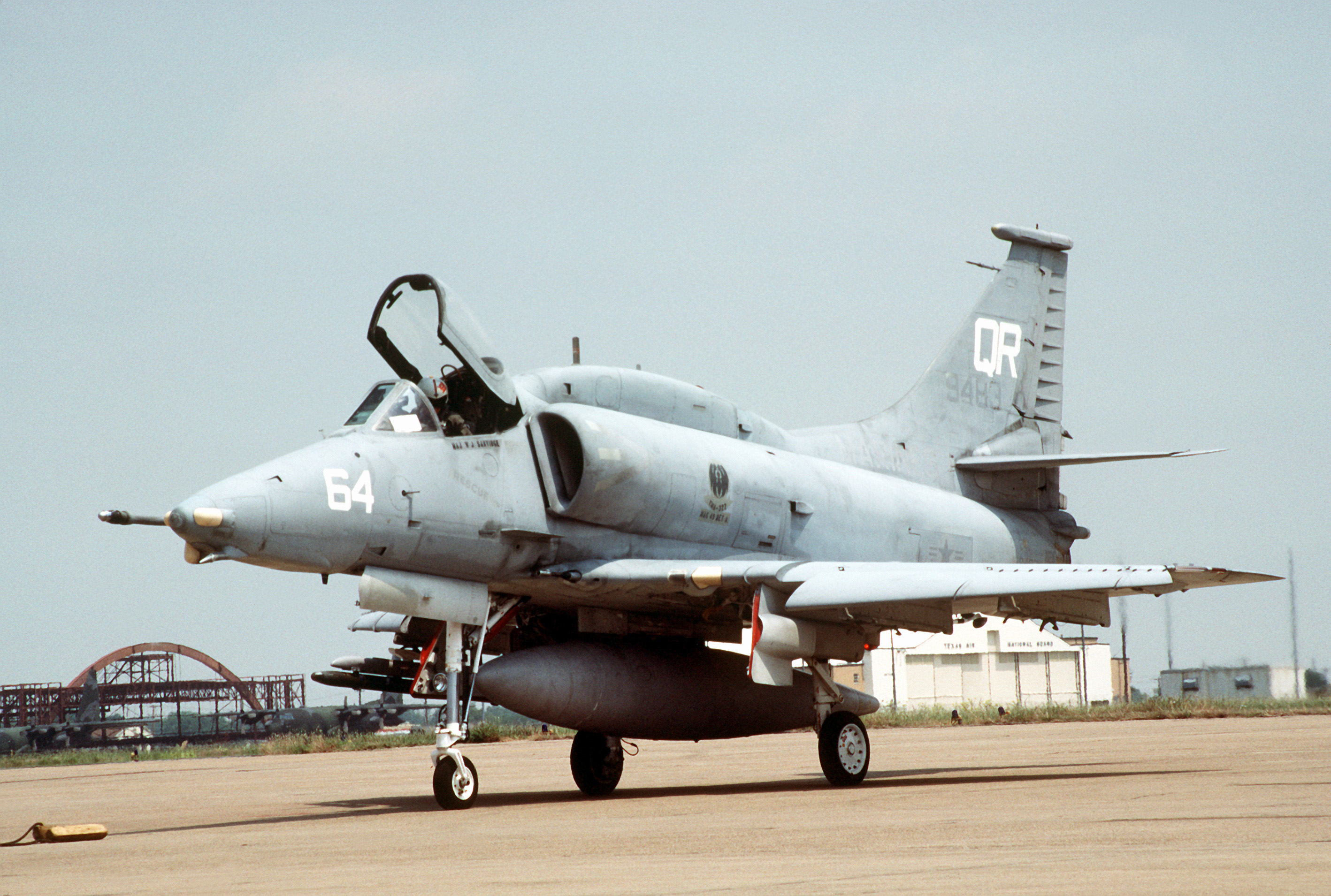 A left front view of a Marine Attack Squadron 322 (VMA-332) A-4M Skyhawk aircraft parked on the flight line.